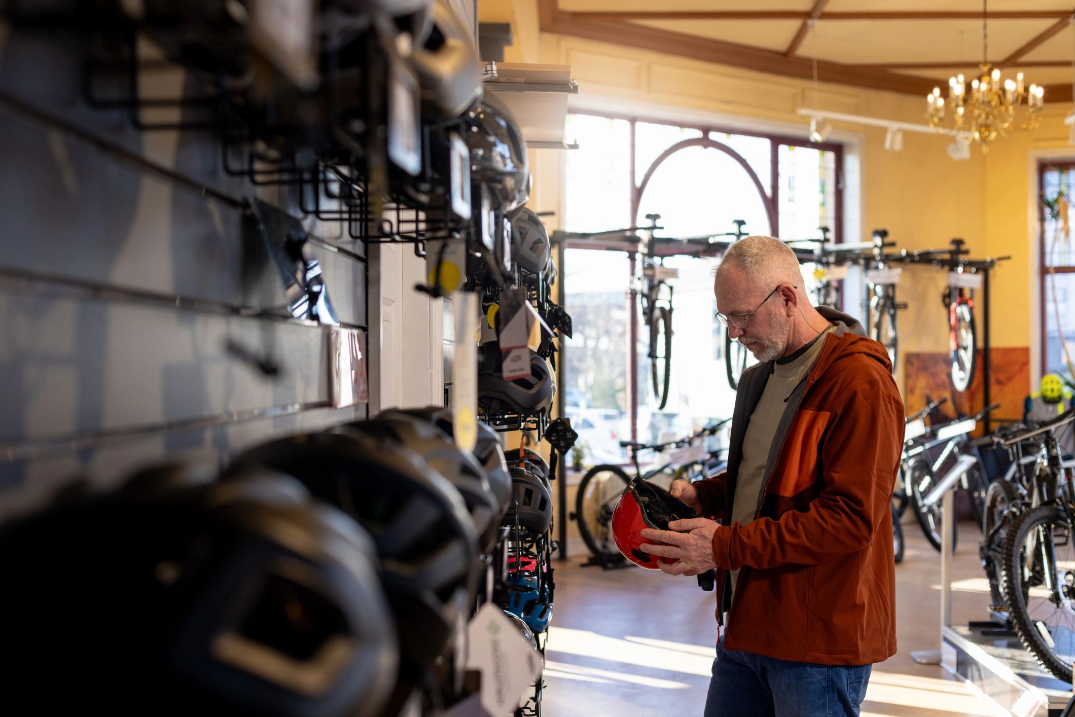 Customer comparing helmets in a retail showroom